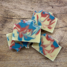 Load image into Gallery viewer, Colorful swirled soap bars on a wooden surface