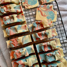 Load image into Gallery viewer, Marbled soap bars on a cooling rack